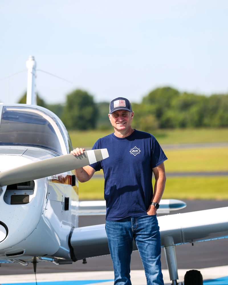 Lee Jacobs, founder and chief instructor of Blue Skies Flight Academy, standing with the school's Piper Cherokee at Upper Cumberland Regional Airport